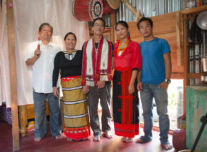 The author, Byron Aihara stands for a portrait with Oja Dingbulung and family.